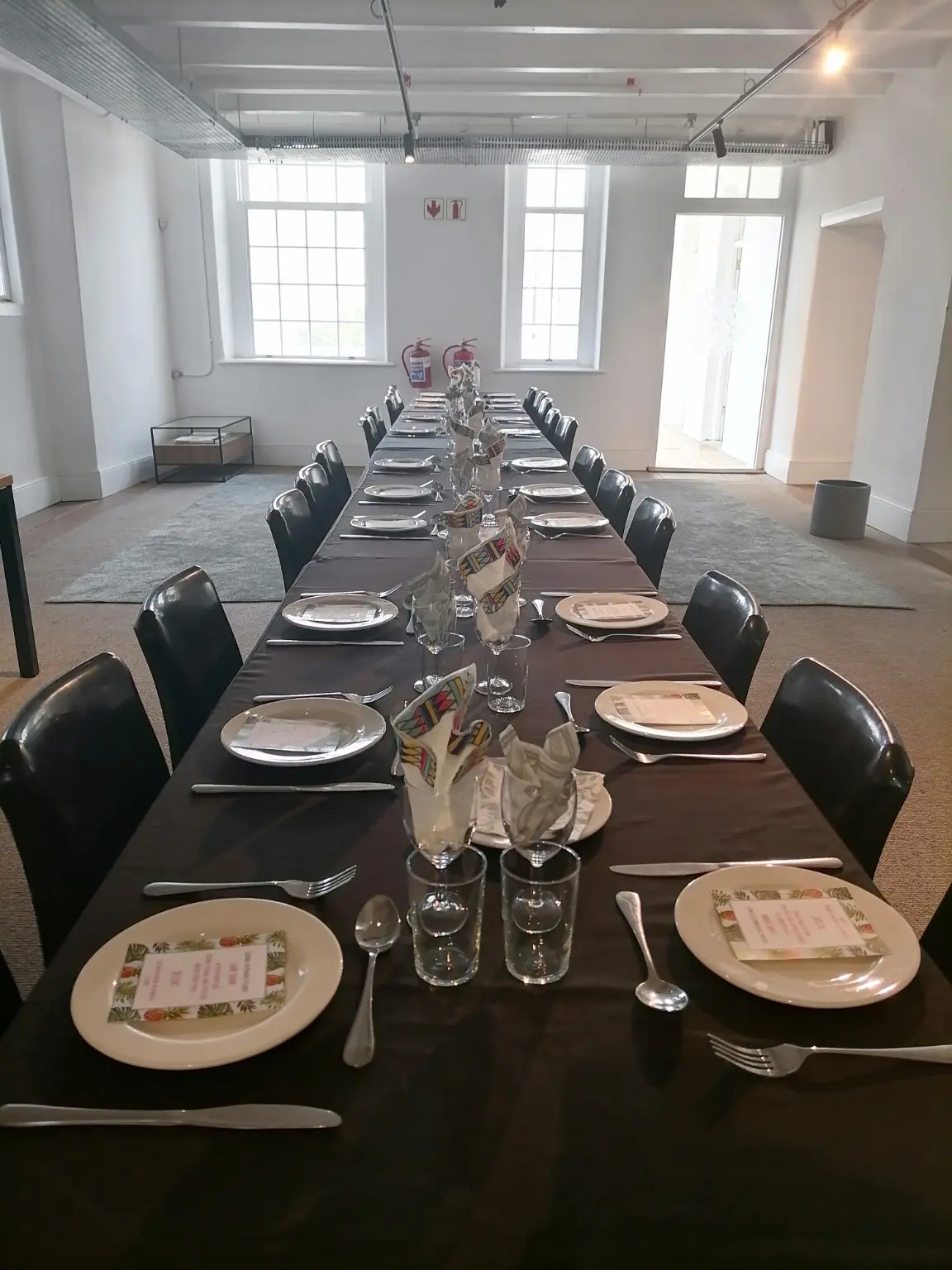 Formal dining table prepared with glassware and place settings